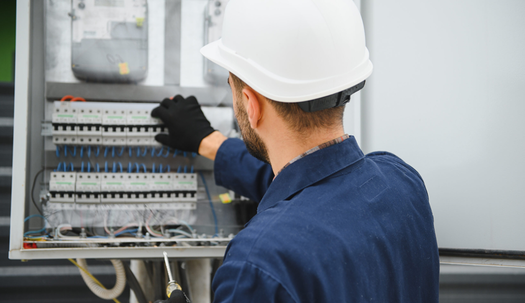 Electricians Service Team technician completing electric panel upgrade on site