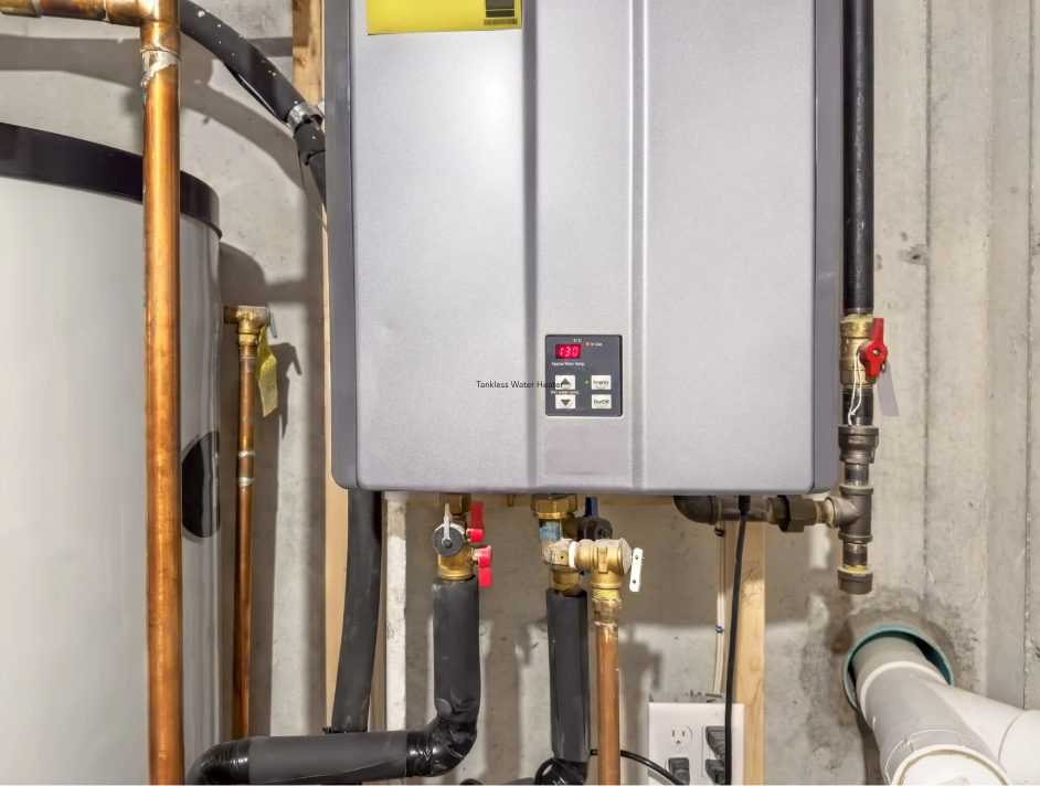 Tankless on-demand water heater installed on basement wall with copper pipes to reduce home energy costs