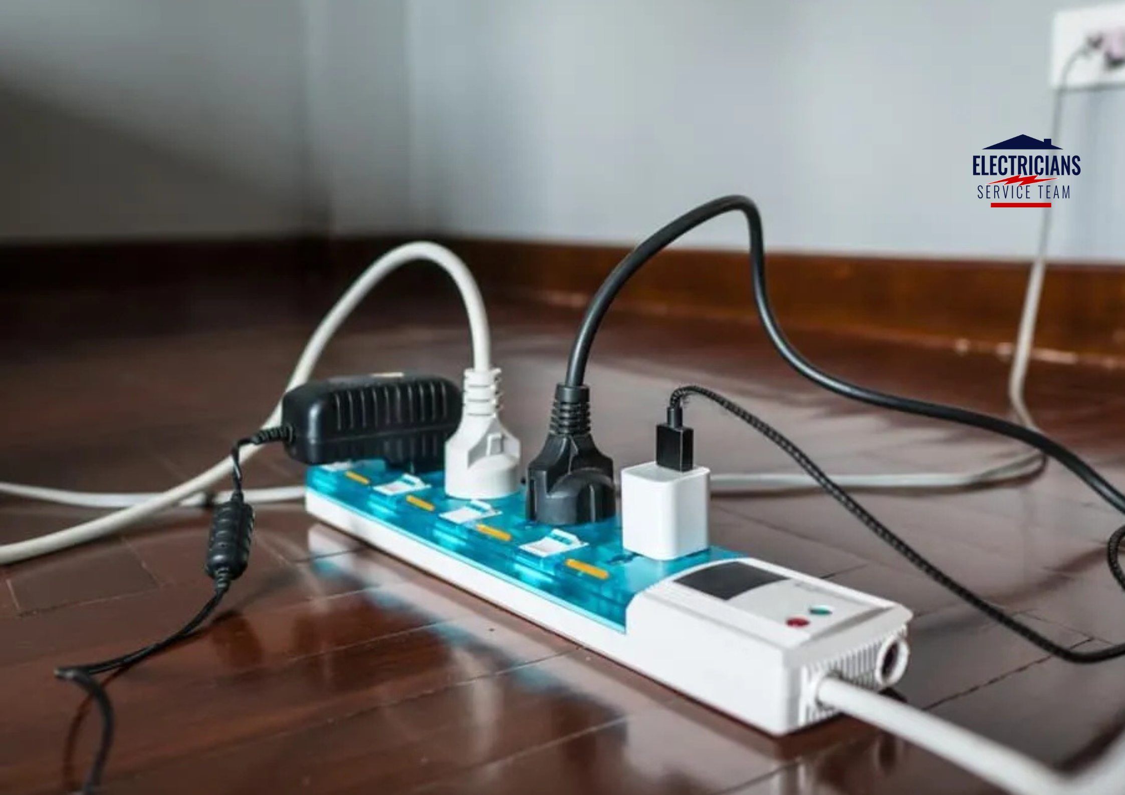 An overloaded power strip with multiple electronic devices plugged in, illustrating common electrical safety risks in the home.