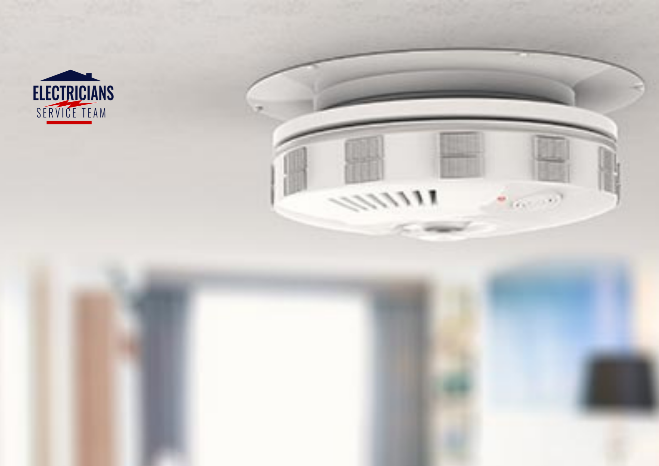 A modern white smoke detector and carbon monoxide alarm installed on a residential ceiling