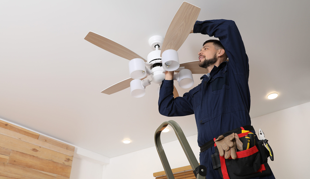 Electricians Service Team technician completing ceiling fan installation on site