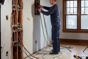 Licensed electrician performing knob and tube wiring replacement work for Electricians Service Team