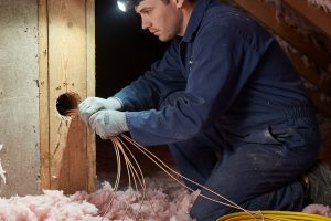 Licensed electrician performing aluminum wiring replacement work for Electricians Service Team